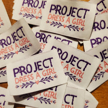 Load image into Gallery viewer, Project Dress A Girl Label
