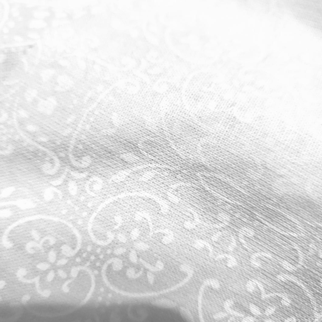 Close-up of white fabric with subtle pattern